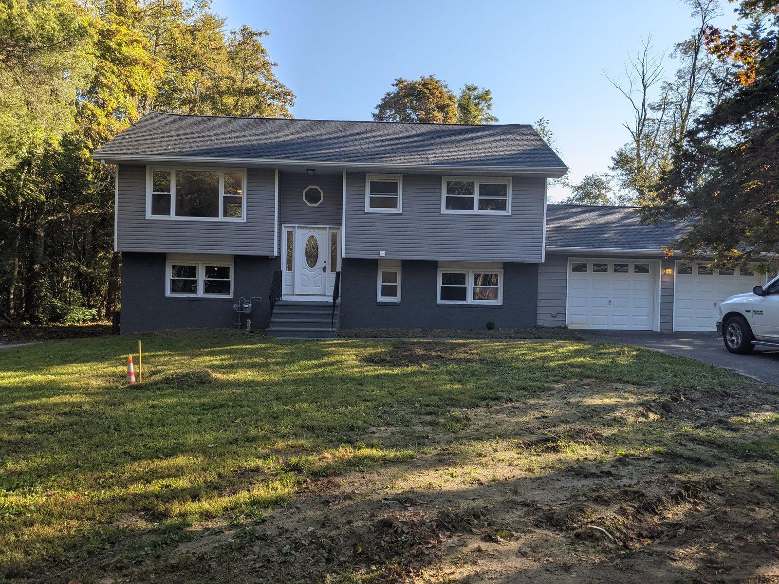 Renovated exterior with new siding, roof and entry