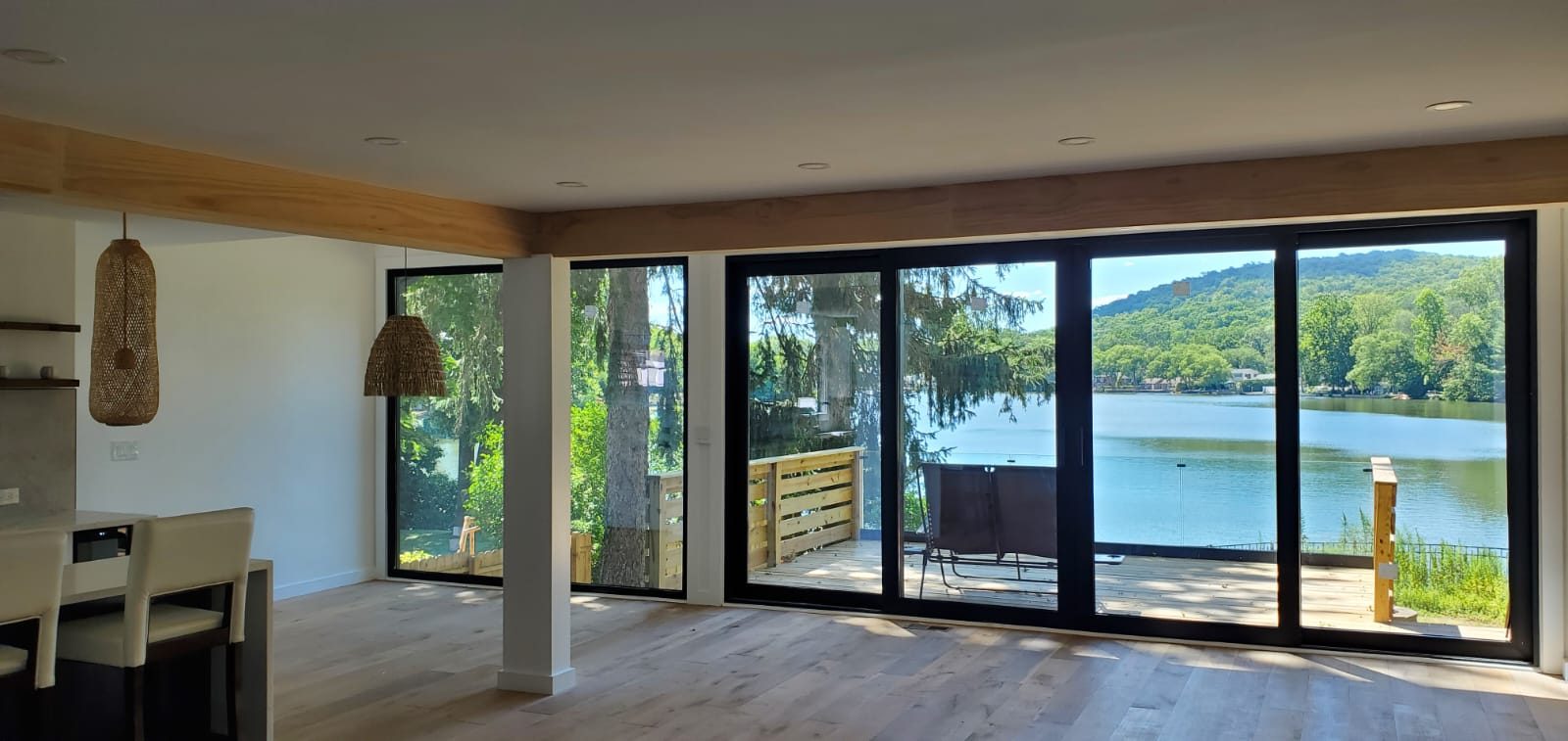 Great room with a full wall of black-framed glass