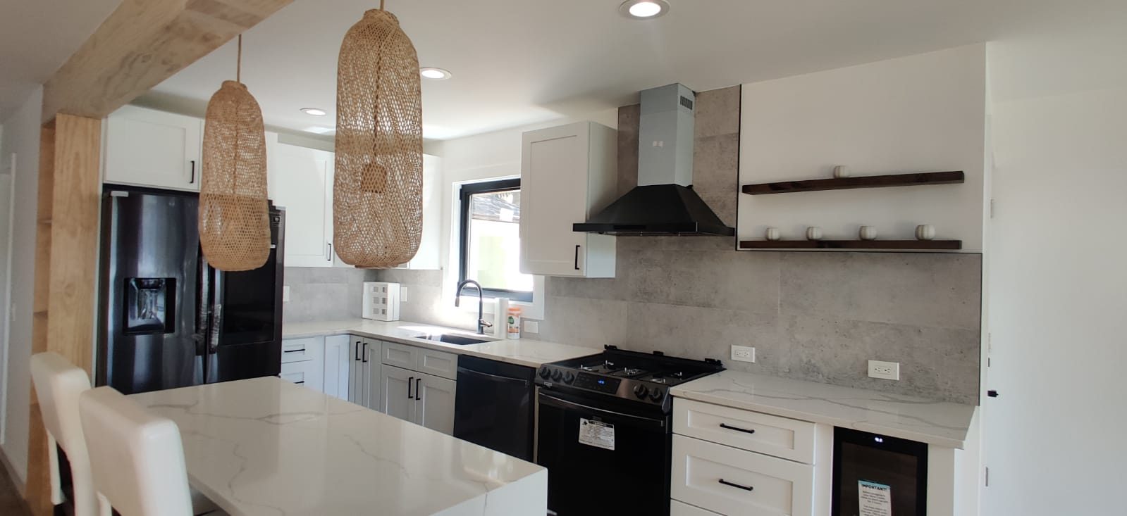 Kitchen with a vented range hood, quartz counters and open shelving